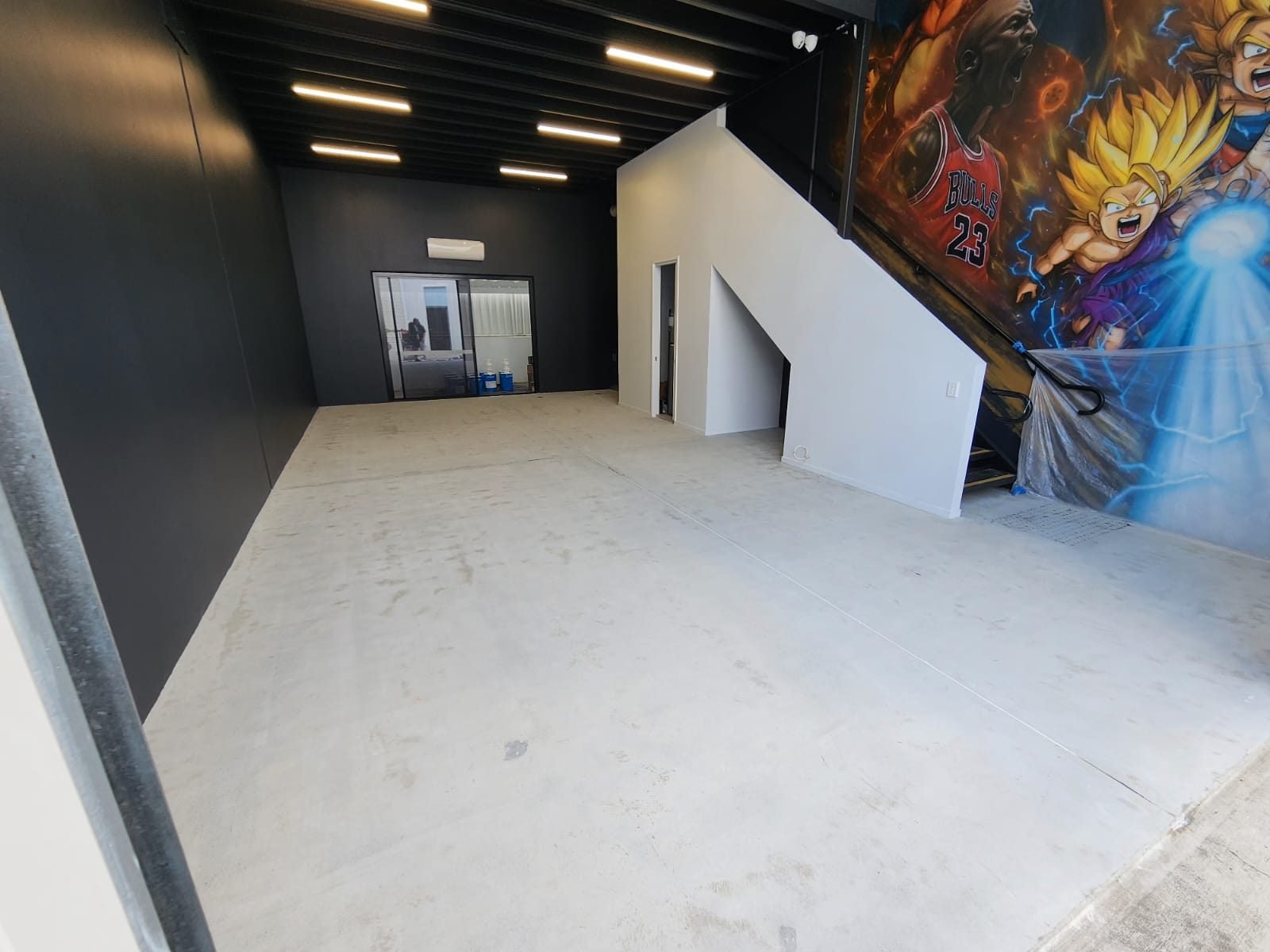 Bare concrete slab in a Brisbane commercial fit-out before epoxy coating