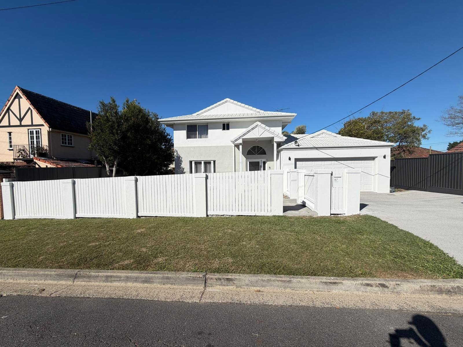 Timber fence painted white in front of a Brisbane home