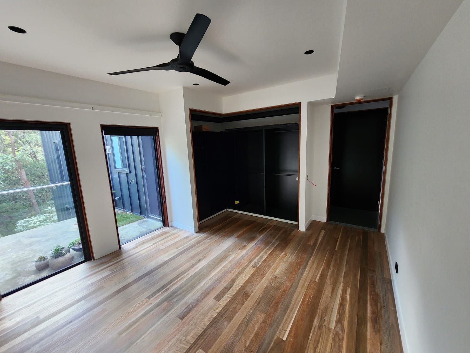 Interior repaint with dark doors and hardwood floors