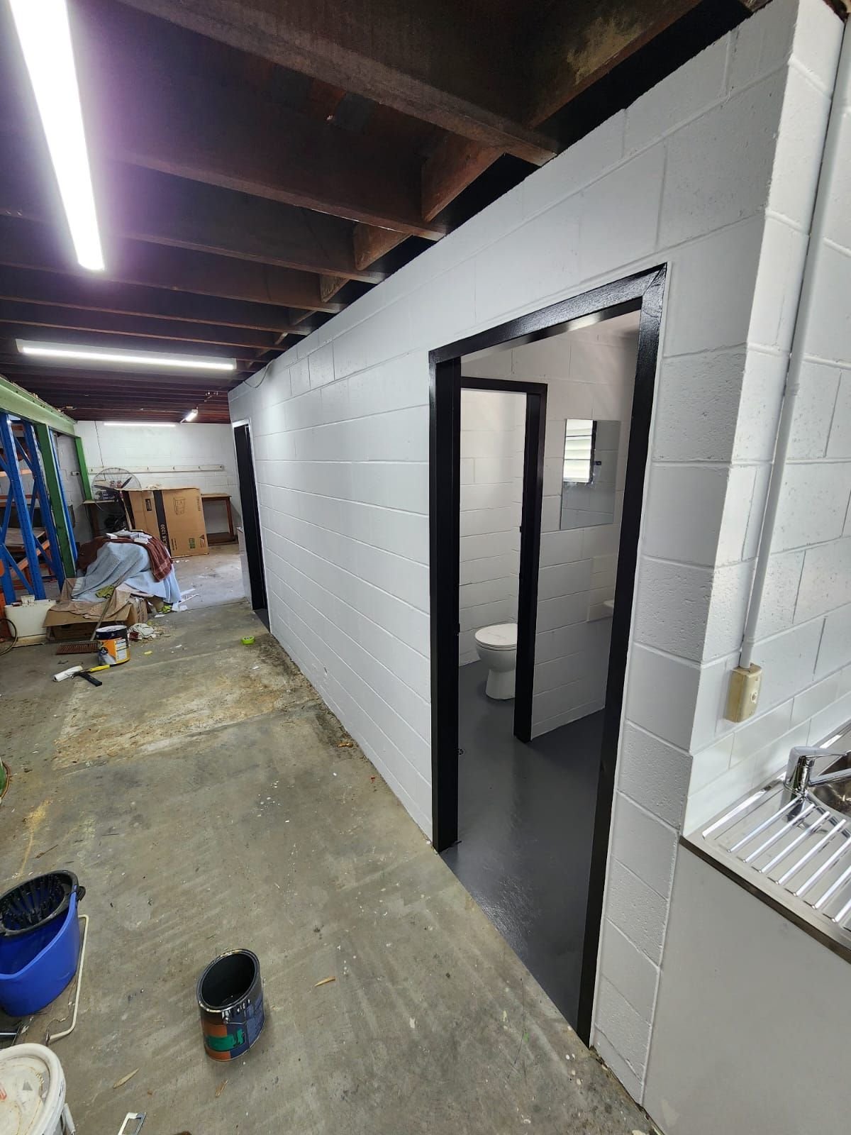 Refurbished amenities corridor with new cubicle doors