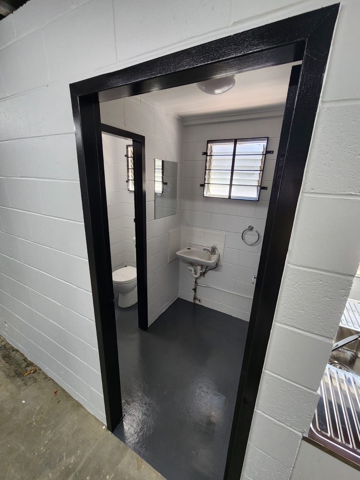Refurbished bathroom cubicle with new doors and flooring