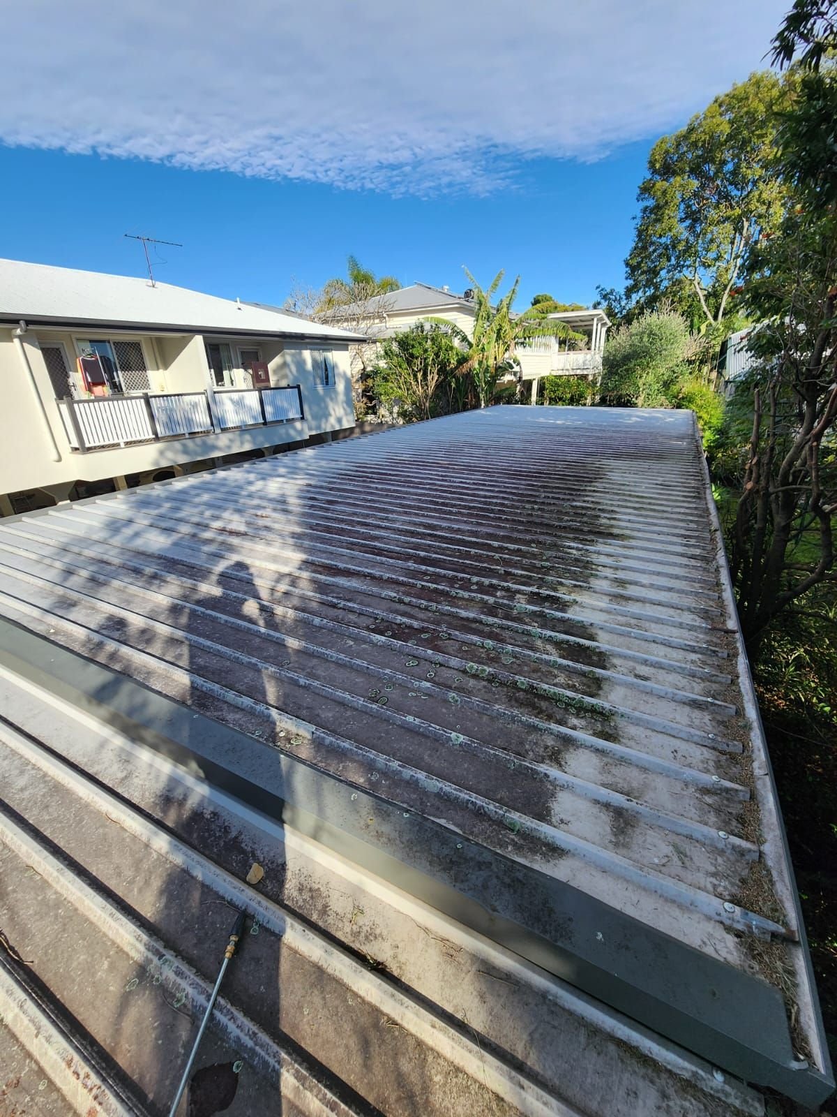 Pressure washing a metal roof in Brisbane